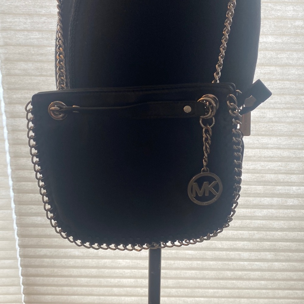 Black leather silver chain Michael Kors crossbody/shoulder bag. 8” W X 7” H